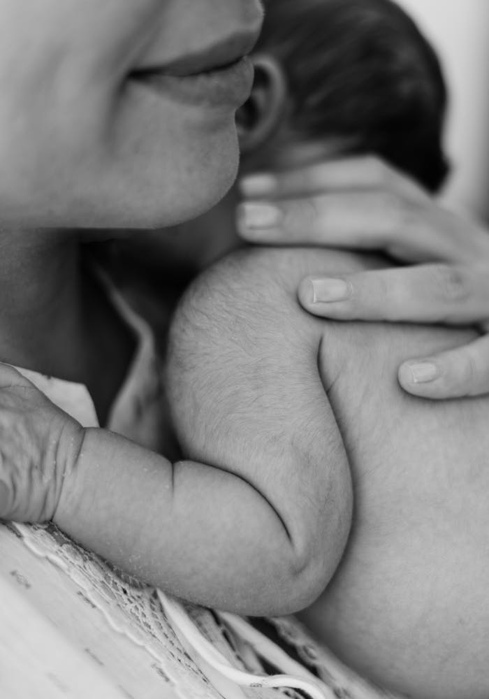 Close-up of a Mother Holding Her Newborn Baby 